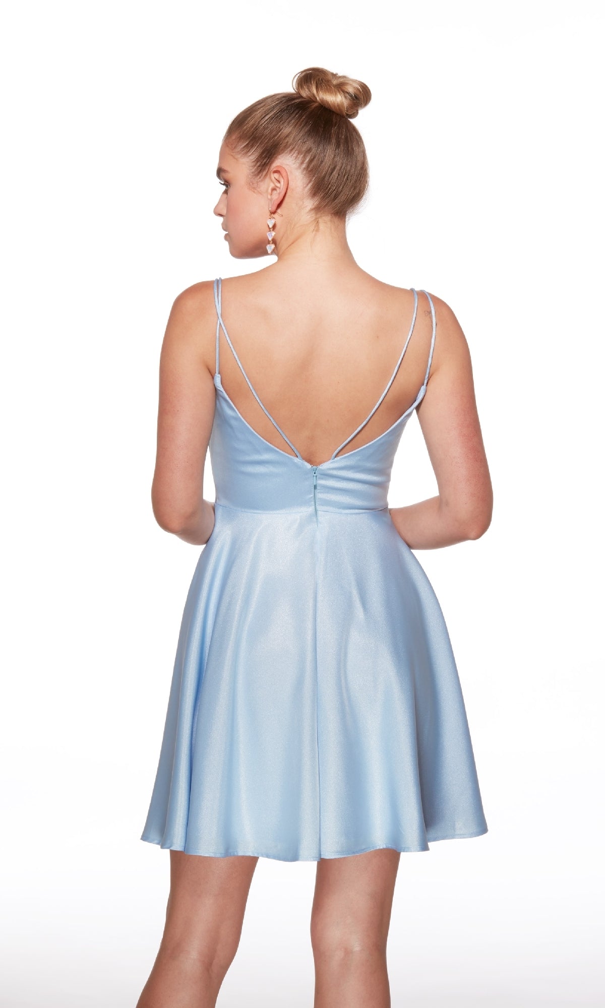 A woman with her hair in a bun models the Alyce 30051 short homecoming dress in light blue satin, featuring thin straps and a low back, standing against a white background.